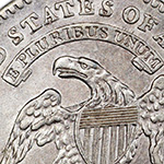 close up of e pluribus unum banner on capped bust dime