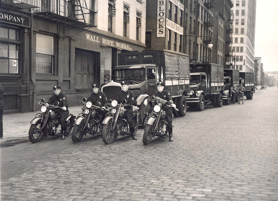 police on motorcycles and trucks parked in front of building