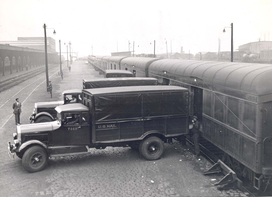 trucks backed up to the door of a rail car