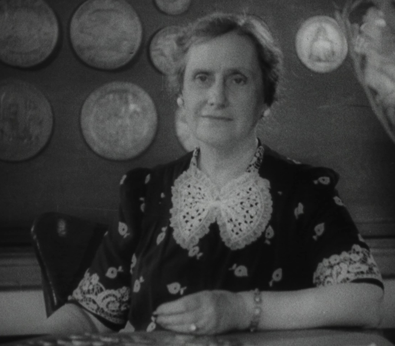 Woman seated at a table.